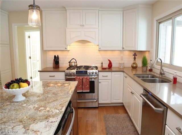31382 Saint Andrews, Westlake, OH 44145 - kitchen featuring appliances with stainless steel finishes, plenty of natural light, wood finished floors, and white cabinetry