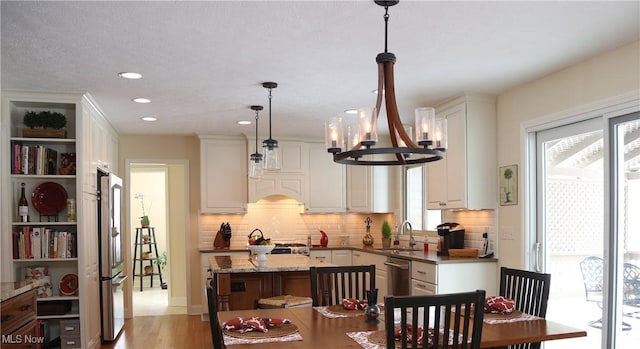 31382 Saint Andrews, Westlake, OH 44145 - kitchen with a kitchen island, appliances with stainless steel finishes, healthy amount of natural light, a chandelier, and recessed lighting