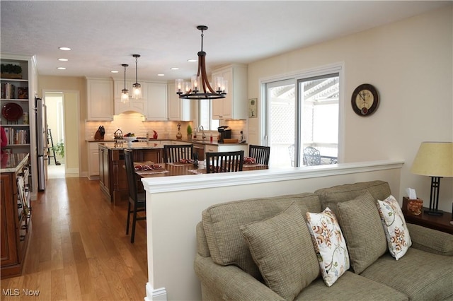 31382 Saint Andrews, Westlake, OH 44145 - kitchen with light wood-type flooring, appliances with stainless steel finishes, tasteful backsplash, white cabinets, and recessed lighting