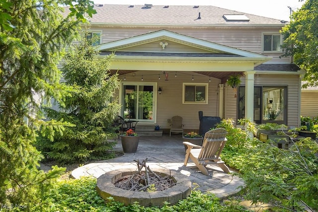 31382 Saint Andrews, Westlake, OH 44145 - back of house featuring a patio area, a fire pit, and roof with shingles