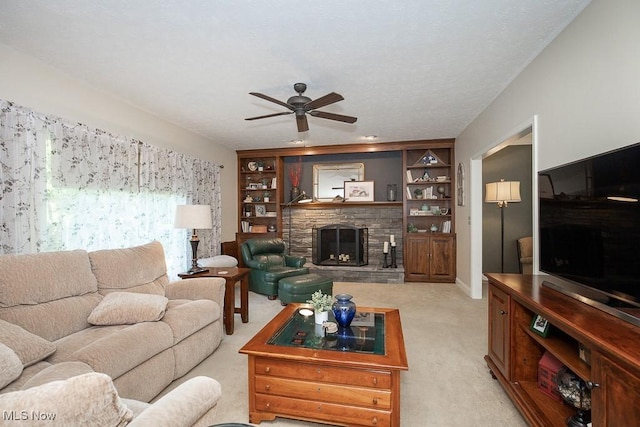 31382 Saint Andrews, Westlake, OH 44145 - living room with light carpet, a stone fireplace, a ceiling fan, and built in features