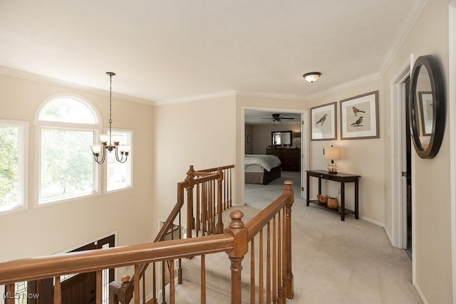 31382 Saint Andrews, Westlake, OH 44145 - hallway with an upstairs landing, light colored carpet, ornamental molding, and a chandelier