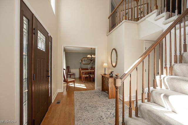 31382 Saint Andrews, Westlake, OH 44145 - entrance foyer featuring stairway, wood finished floors, a high ceiling, and a chandelier