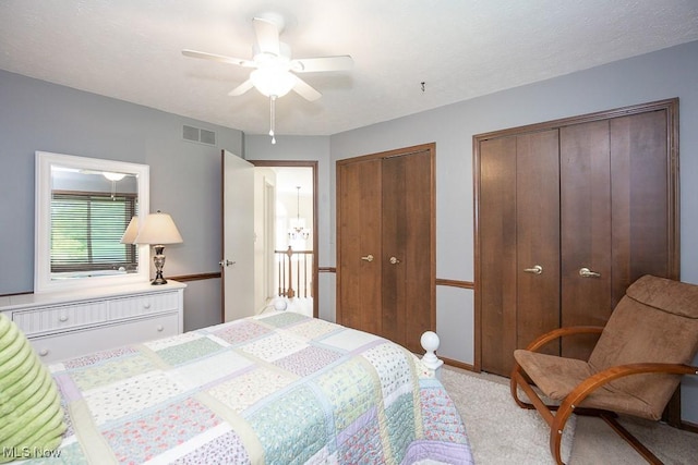 31382 Saint Andrews, Westlake, OH 44145 - bedroom featuring two closets, light colored carpet, and ceiling fan