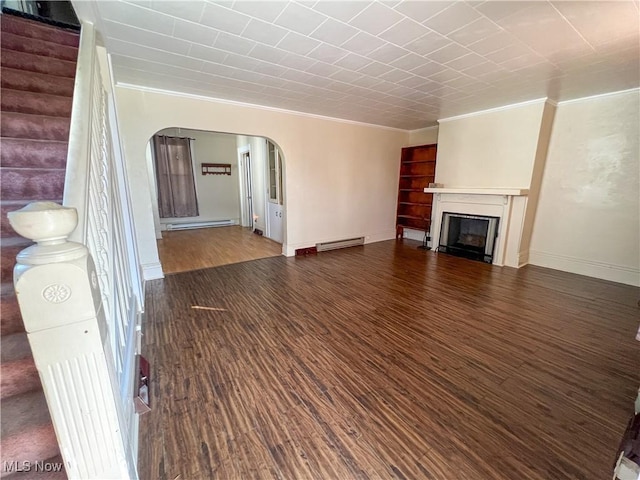 1030 Saint George St, East Liverpool, OH 43920 - unfurnished living room with arched walkways, ornamental molding, wood finished floors, a fireplace, and a baseboard radiator