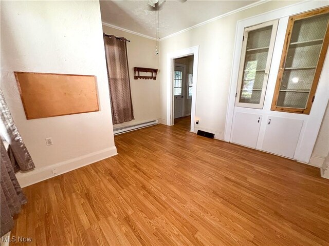 1030 Saint George St, East Liverpool, OH 43920 - unfurnished room with baseboard heating, light wood finished floors, and ornamental molding