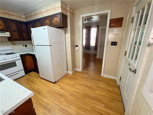 1030 Saint George St, East Liverpool, OH 43920 - kitchen featuring white appliances, under cabinet range hood, light countertops, and light wood finished floors