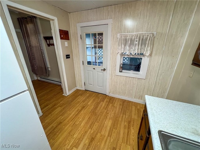 1030 Saint George St, East Liverpool, OH 43920 - doorway to outside with a baseboard radiator and light wood-style floors
