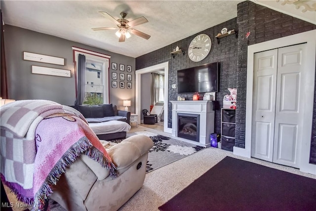 37 S Cedar St, Geneva, OH 44041 - living area with a ceiling fan, a glass covered fireplace, and a textured ceiling