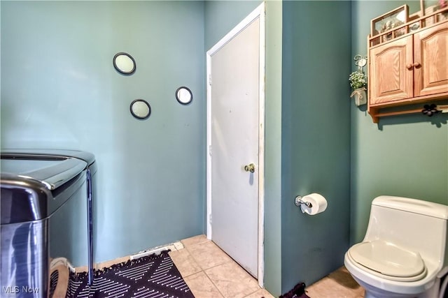 37 S Cedar St, Geneva, OH 44041 - laundry area featuring washing machine and clothes dryer and light tile patterned flooring