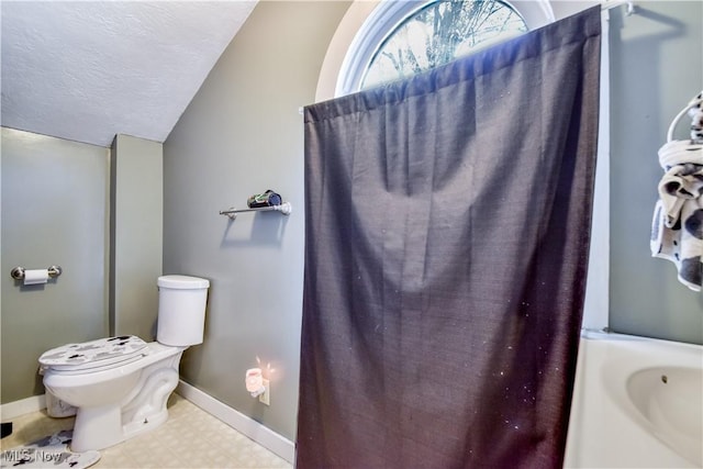 37 S Cedar St, Geneva, OH 44041 - full bath with tile patterned floors, lofted ceiling, and a textured ceiling