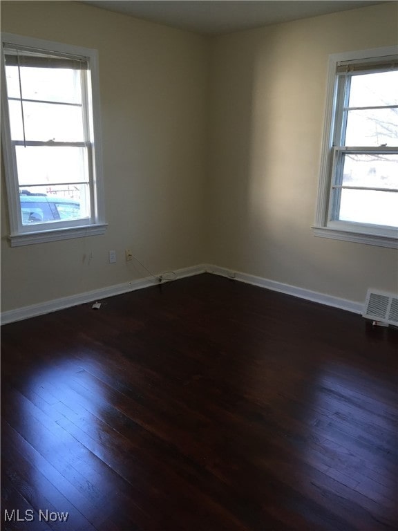 4211 Torrington Ave, Parma, OH 44134 - spare room with dark wood-style floors and baseboards