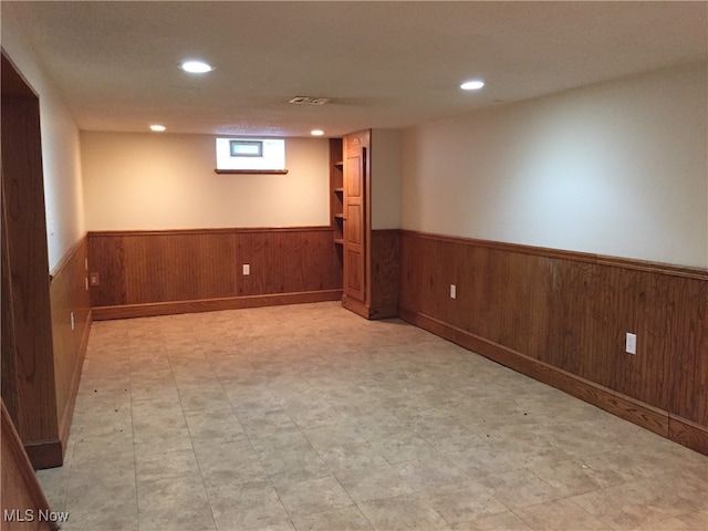 4211 Torrington Ave, Parma, OH 44134 - below grade area featuring a wainscoted wall, recessed lighting, wood walls, and light flooring