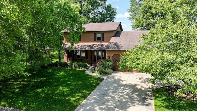 26788 Skyline Dr, Olmsted Twp, OH 44138 - view of front of property with a garage, a front lawn, driveway, and covered porch