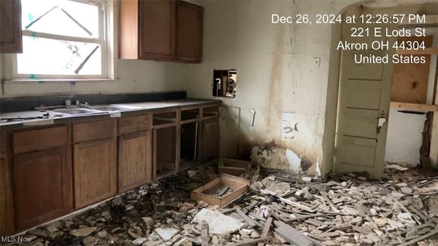 221 E Lods St, Akron, OH 44304 - kitchen with brown cabinetry and a sink