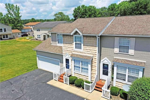 3189 Woodland Trl Unit A, Cortland, OH 44410 - view of front of property with a shingled roof, driveway, a front yard, and a residential view