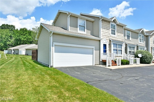 3189 Woodland Trl Unit A, Cortland, OH 44410 - view of front facade with asphalt driveway, a front yard, and an attached garage