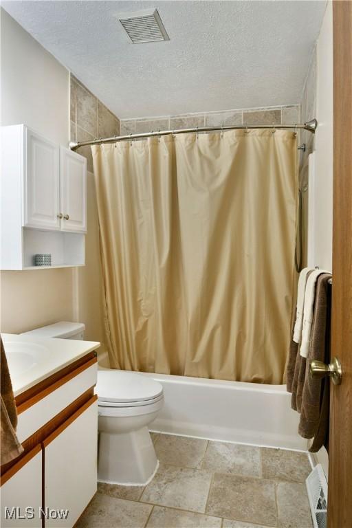 3189 Woodland Trl Unit A, Cortland, OH 44410 - bathroom featuring vanity, shower / bath combination with curtain, and a textured ceiling