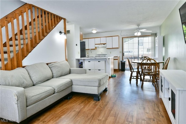 3189 Woodland Trl Unit A, Cortland, OH 44410 - living area with a ceiling fan, wood finished floors, and stairway