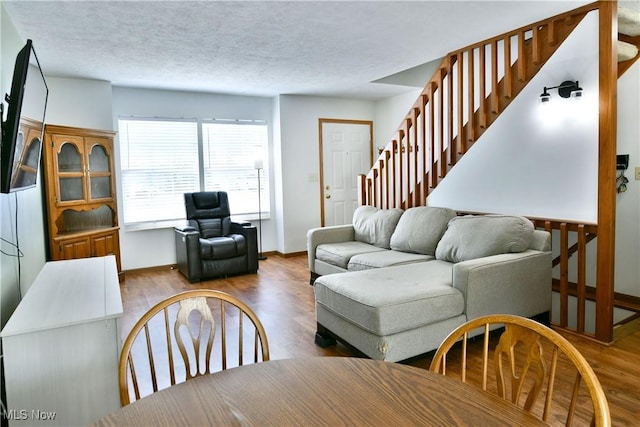 3189 Woodland Trl Unit A, Cortland, OH 44410 - living area featuring stairway, wood finished floors, and a textured ceiling