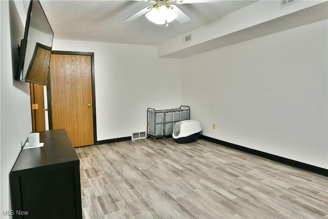 3189 Woodland Trl Unit A, Cortland, OH 44410 - unfurnished bedroom featuring light wood finished floors and a ceiling fan