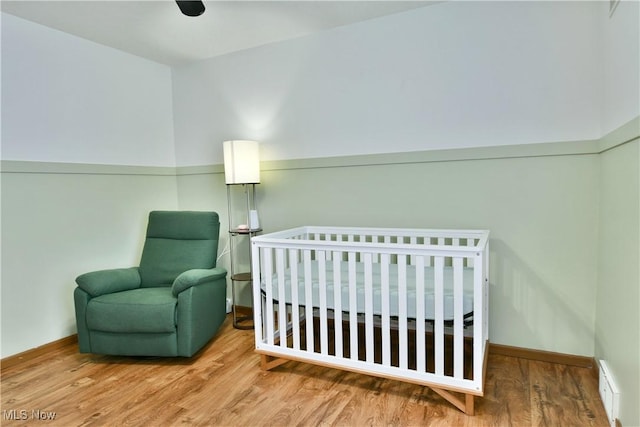 3189 Woodland Trl Unit A, Cortland, OH 44410 - bedroom featuring wood finished floors, a baseboard heating unit, and a nursery area