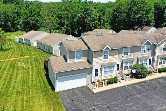 3189 Woodland Trl Unit A, Cortland, OH 44410 - view of front of house with driveway, a front lawn, and roof with shingles