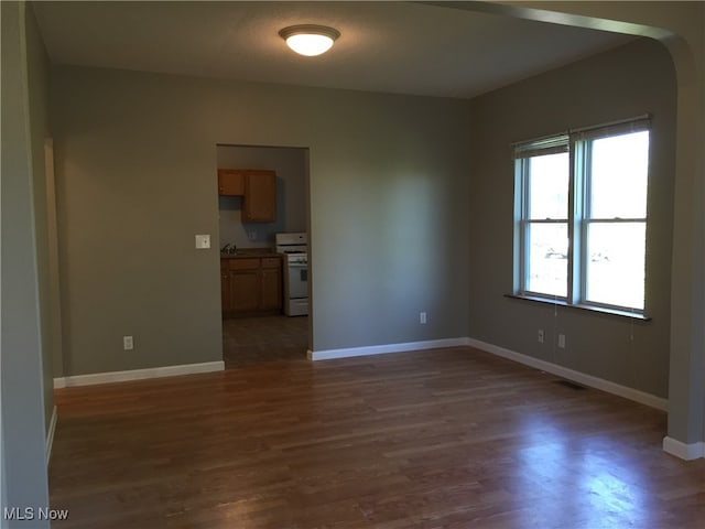 3439 Tuxedo Ave, Parma, OH 44134 - empty room featuring arched walkways and wood finished floors