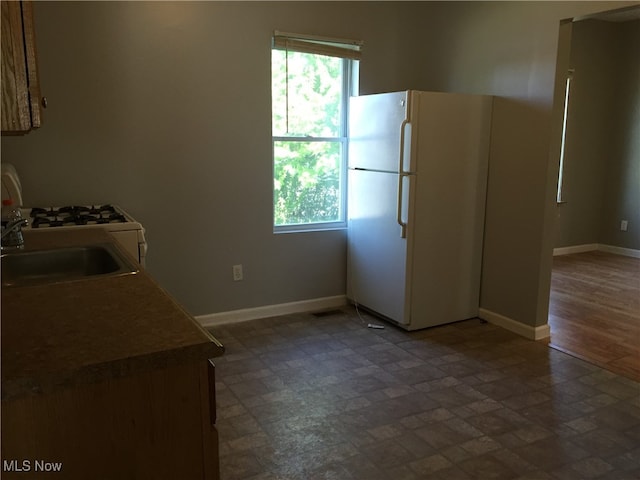 3439 Tuxedo Ave, Parma, OH 44134 - kitchen featuring freestanding refrigerator and baseboards