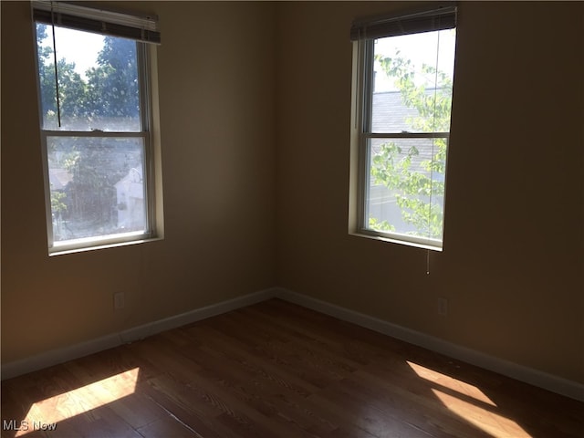 3439 Tuxedo Ave, Parma, OH 44134 - spare room featuring dark wood-style floors and healthy amount of natural light