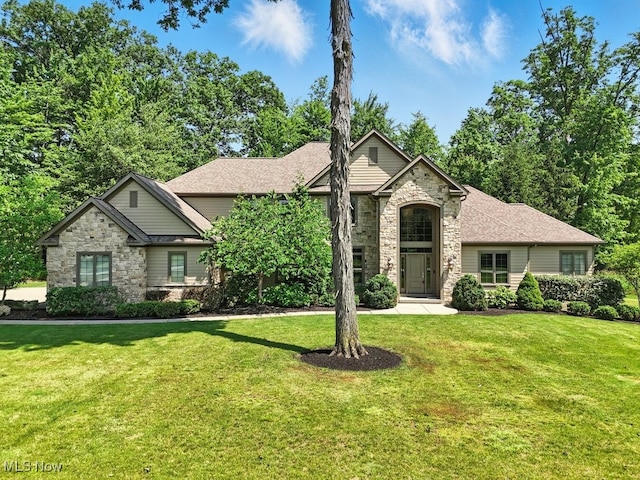 3880 Waterford Ct, Orange, OH 44122 - view of front facade with stone siding and a front lawn