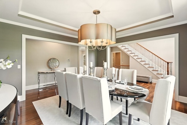 3880 Waterford Ct, Orange, OH 44122 - dining room featuring a chandelier, stairs, crown molding, wood finished floors, and a tray ceiling