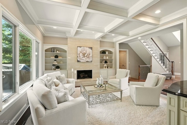 3880 Waterford Ct, Orange, OH 44122 - living area with built in shelves, beamed ceiling, coffered ceiling, stairs, and a premium fireplace