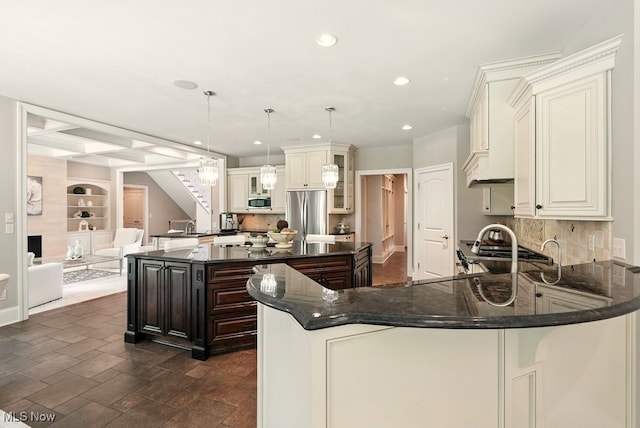 3880 Waterford Ct, Orange, OH 44122 - kitchen featuring appliances with stainless steel finishes, a center island, recessed lighting, decorative backsplash, and glass insert cabinets