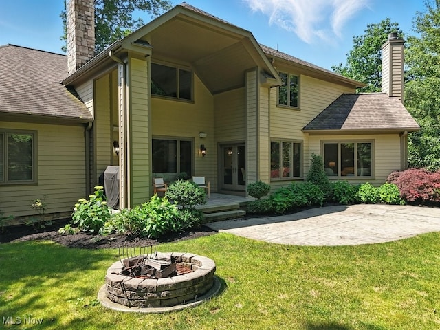 3880 Waterford Ct, Orange, OH 44122 - back of house featuring a chimney, an outdoor fire pit, a yard, a patio, and french doors