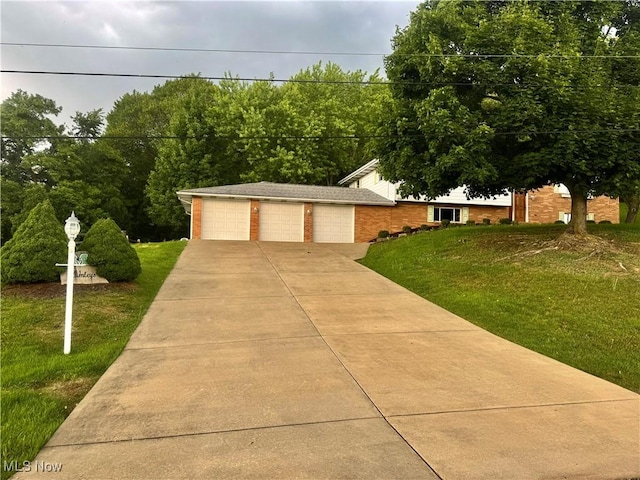 1104 Lantern, East Liverpool, OH 43920 - view of front facade with a front yard, a garage, and brick siding