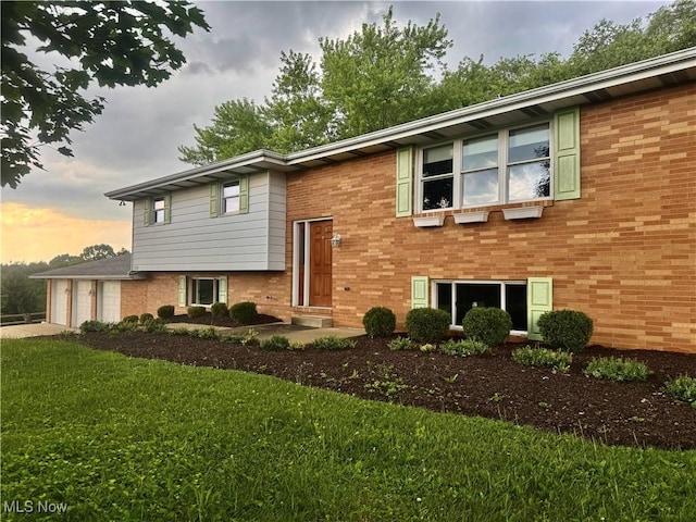 1104 Lantern, East Liverpool, OH 43920 - bi-level home with brick siding, a front lawn, driveway, and a garage