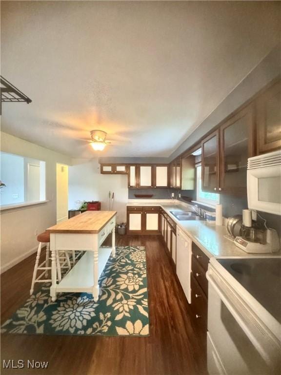 1104 Lantern, East Liverpool, OH 43920 - kitchen with white appliances, dark wood finished floors, glass insert cabinets, butcher block counters, and healthy amount of natural light