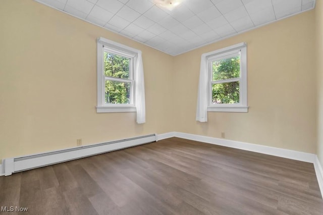 4706 Lansing Dr, North Olmsted, OH 44070 - empty room featuring a baseboard radiator, plenty of natural light, and dark wood-type flooring