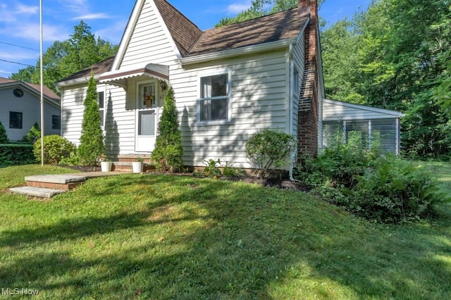4706 Lansing Dr, North Olmsted, OH 44070 - view of front of home featuring a chimney, a front yard, and roof with shingles
