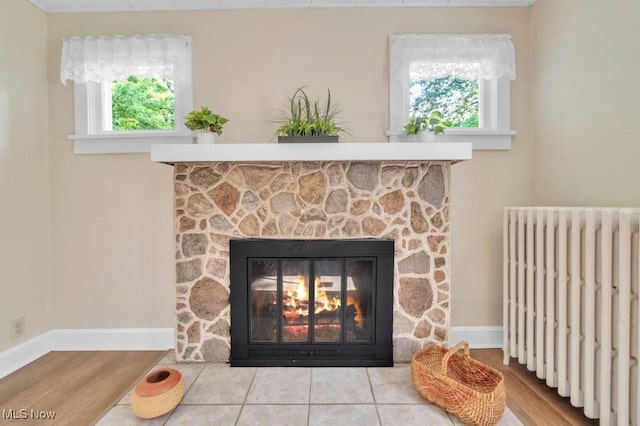 4706 Lansing Dr, North Olmsted, OH 44070 - detailed view of radiator heating unit, a fireplace, and wood finished floors