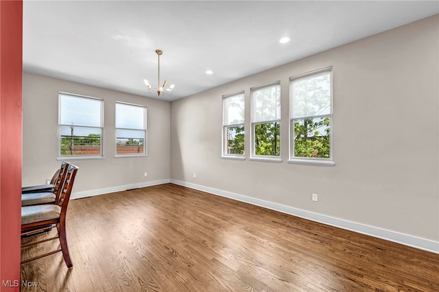 11901 Detroit Ave, Lakewood, OH 44107 - unfurnished dining area with a chandelier, wood finished floors, and recessed lighting