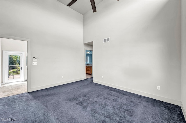 11901 Detroit Ave, Lakewood, OH 44107 - unfurnished room featuring a ceiling fan, dark carpet, and a towering ceiling