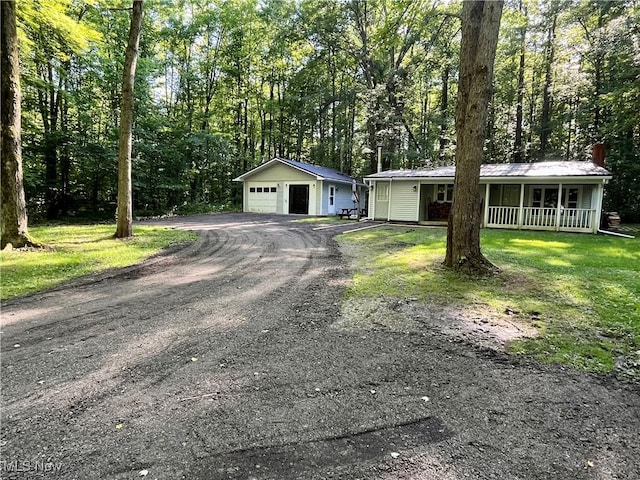 4807 Laskey Rd, Rome, OH 44085 - ranch-style home with a porch, an outdoor structure, a garage, a metal roof, and driveway