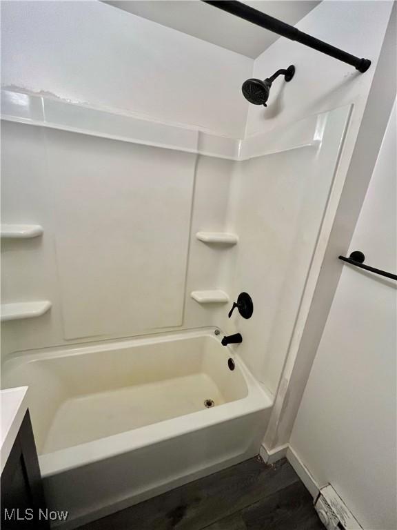 4807 Laskey Rd, Rome, OH 44085 - full bathroom with washtub / shower combination, wood finished floors, a baseboard radiator, and vanity