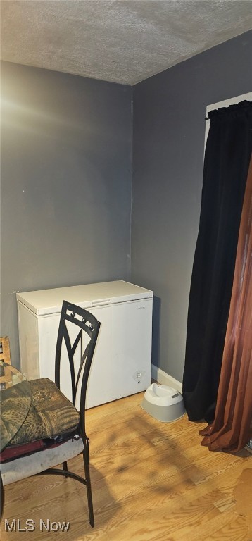 425 N Osborn Ave, Youngstown, OH 44509 - bedroom with a textured ceiling, fridge, and light wood-type flooring