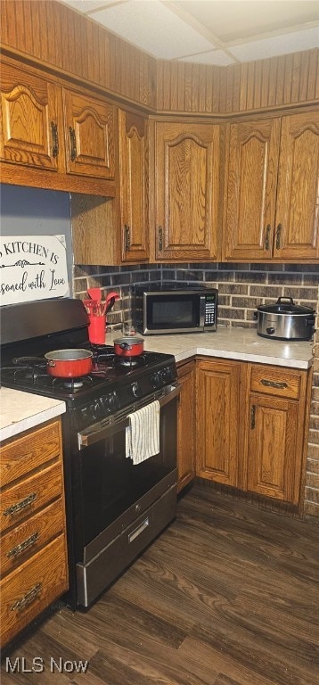 425 N Osborn Ave, Youngstown, OH 44509 - kitchen with gas stove, light countertops, brown cabinets, and tasteful backsplash