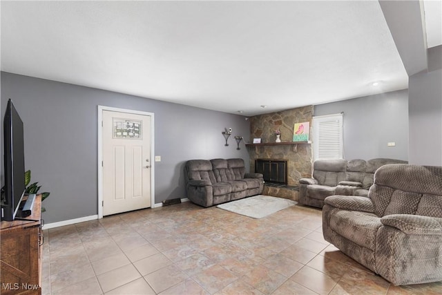 1558 Windcrest St NW, North Canton, OH 44720 - living room featuring a stone fireplace and light tile patterned floors