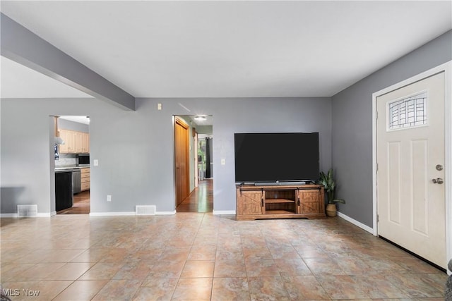 1558 Windcrest St NW, North Canton, OH 44720 - unfurnished living room featuring light tile patterned flooring and beamed ceiling