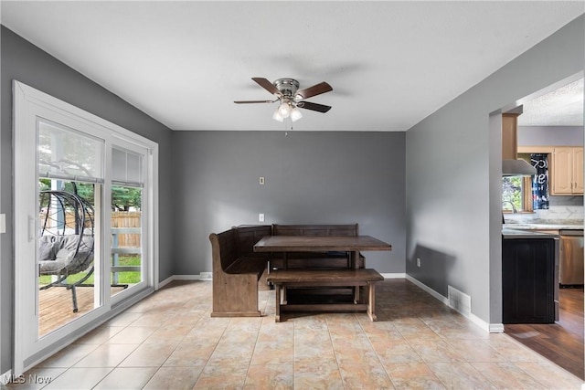 1558 Windcrest St NW, North Canton, OH 44720 - dining area featuring a ceiling fan and baseboards